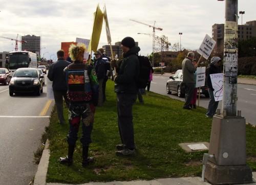 Pro-choicer hiding pro-life sign with his own.